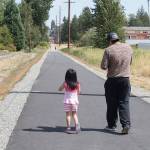 Jesus Dios and his daughter Alyssa, 4, walk down the Tolt Trial in Kenmore after the ribbon cutting Aug. 23. Megan Campbell, Bothell/Kenmore Reporter