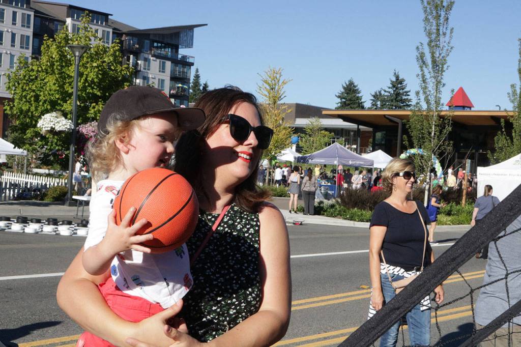 Stephanie Skuse and her two-year-old son, Jack, practice tossing balls during the #WhyILoveKenmore event Saturday. Stephanie said she loves Kenmore for &ldquo;so many reasons,&rdquo; like the strong community and family-friendly atmosphere. Megan Campbell, Bothell/Kenmore Reporter