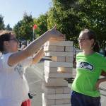 Amber Mehdipour, 14, stacks a Janga block during the #WhyILoveKenmore Summer Party Saturday while Grace Karlinsey, 14, looks on. Megan Campbell, Bothell/Kenmore Reporter