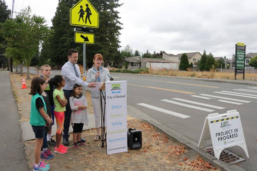 Skyview Middle School Principal Dawn Mark speaks about the new signal in front of Skyview and Canyon Creek Elementary School. Canyon Creek Principal Bruce Denton and students from Canyon Creek stand by. Megan Campbell, Bothell/Kenmore Reporter
