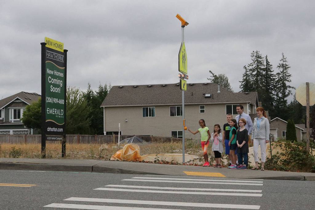 Canyon Creek Elementary School students demonstrate how the new signal at 35th Avenue Southeast and 214th Place Southeast in front of Canyon Creek Elementary and Skyview Middle School works. Megan Campbell, Bothell/Kenmore Reporter
