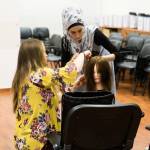 Jessica Dahl of The Beyond Project instructs a student in Lebanon on how to cut hair. Courtesy of Rachel Hile