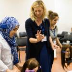 Rachel Hile of The Beyond Project oversees a student in Lebanon learning how to cut and style hair. Courtesy of Rachel Hile