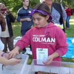 Lily DiGioia, 9, pets a salamander during Outdoor Education Day on Sept. 22. Courtesy of PACE at Woodmoor
