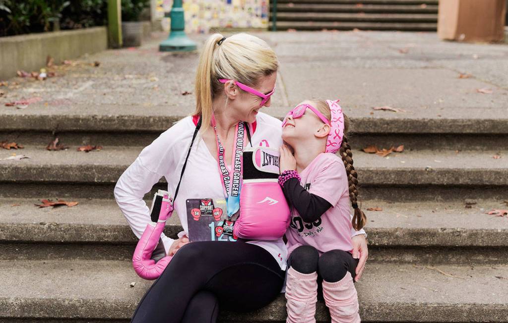 Janae Smith and daughter Brooklyn share a smile in their pink gear for breast cancer awareness. Courtesy of Jami West Photography