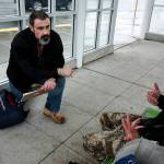 Volunteer Paul Olson (left), of Everett, completes a survey with a man at a bus stop on Smokey Point Boulevard on Tuesday, Jan. 23. Olson, a former U.S. Army infantryman, was homeless for two months following his time in the military. Ian Terry, The Herald