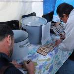 UW Bothell students fill out their wooden passports. Courtesy of Marwa Popal