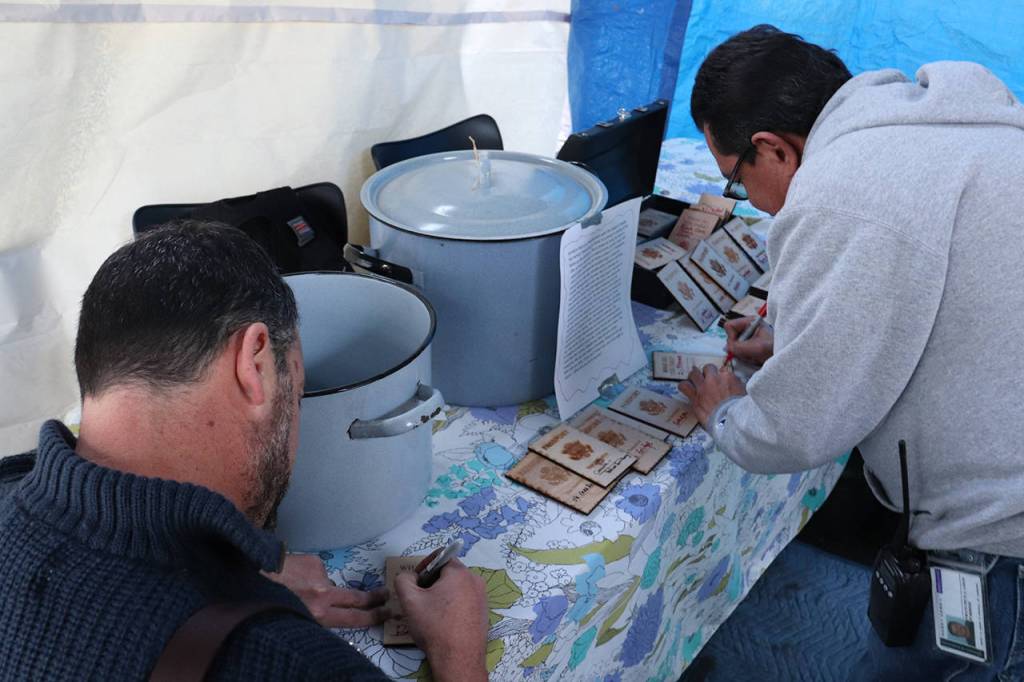 UW Bothell students fill out their wooden passports. Courtesy of Marwa Popal