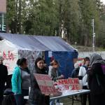 Students from University of Washington Bothells Global Agitation class invite passersby to check out their American Refugee art installation on campus. Courtesy of Marwa Popal
