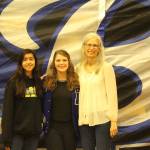 Bothell Highs Monserrat Lopez (left) and Faith Brooks (center) are pictured with Cougar athletic director Yonni Mills during a Feb. 7 event in which Lopez received an all-state cross-country team award and Brooks received an AAU Volleyball All-American award for her academic and athletic excellence. Lopez had one of the top 25 fastest times  and best as a freshman  across all six classifications. Her top mark was 18 minutes, 31 seconds during her 11th-place finish at the 4A state meet. Courtesy photo
