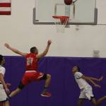 Bothells Cameron Tyson, left, and DaVicious Wilson flank Mount Sis Bijon Sidhu. Andy Nystrom, Reporter