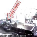 A photo of the suspect vehicle. Possibly mid-1990s Nissan Maxima or Toyota Camry, with the passenger-side front wheel all black. The passenger-side rear window may be damaged or missing. Only the driver side brake light works. Photo courtesy of Bothell Police Department