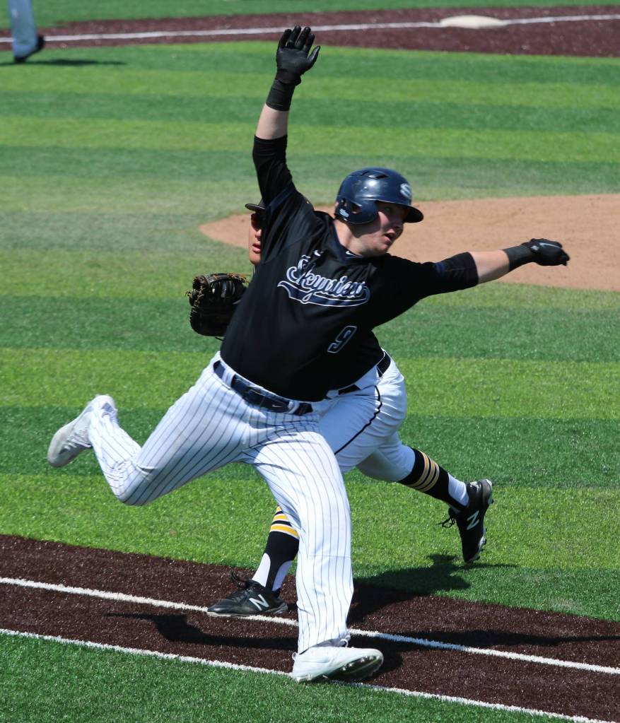 Eunsang Yu, behind, tags out a runner along the first-base line. Andy Nystrom / staff photo