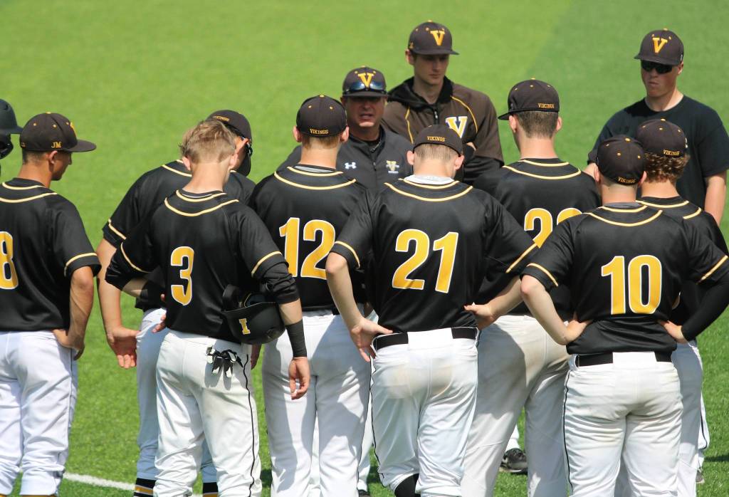 Coach Craig Bishop  between No. 12 and No. 21  addresses his players after their state loss. Andy Nystrom / staff photo