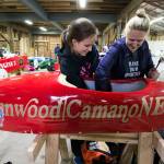 First year driver Charlotte McNeely, 13, and her mother, Stephanie, work their Super Stock soap box derby car brakes at the barn. (Andy Bronson / The Herald)