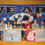 The following Bothell High student athletes recently committed to playing sports as they begin their college years: (pictured right to left with assistant principal Juan Price) Andrew Schuller, Belleveue College, tennis; Kyler Parris, Occidental College, football; Matthew Howard, Washington State University, track; Brandon Simmons, Western Washington University, track; Tyler Schenck, Western Washington University, track; Mallory Harder, Western Washington University, track; Ryan Witters, Western Washington University, track; Enoch Stevens, Western Washington University, track. Photo courtesy of Nancy Murray