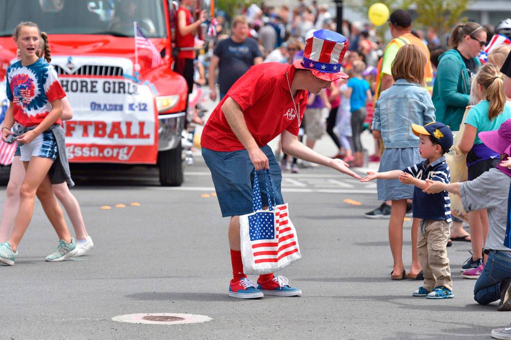 Parade goers receive candy and other treats during the event on July 4. Photo courtesy of Greg Nelson