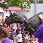 A friendly dinosaur from a birthday party planning company marches in the parade. Photo courtesy of Greg Nelson