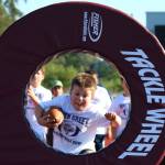 Daxton Boyles prepares to dive through the Tackle Wheel at the North Creek High football camp on July 25. Andy Nystrom / staff photo