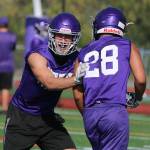 North Creek senior Shea Hoogerwerf, left, bumps a teammate during training on Aug. 17. Andy Nystrom / staff photo