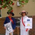 Margaret Carroll (left) and JoAnne Hunt hold signs that advocate for womens rights, based on the suffragettes from 1920. Courtesy of the Bothell Historical Museum
