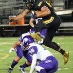 Inglemoors Quentin Moore hurdles a North Creek runner. Photo courtesy of Sandy Waara