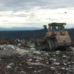 A tractor moves to push trash away from where it was emptied from a cargo trailer atop the Cedar Hills Regional Landfill. An eighth and final section of the landfill is almost ready to come online, extending the life of the landfill through 2028. Aaron Kunkler/staff photo
