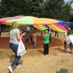 Play Day attendees have some parachute fun at Rhododendron Park in Kenmore. Reporter file photo