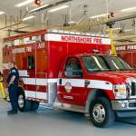 Responders rescue man pinned under garbage truck in Kenmore