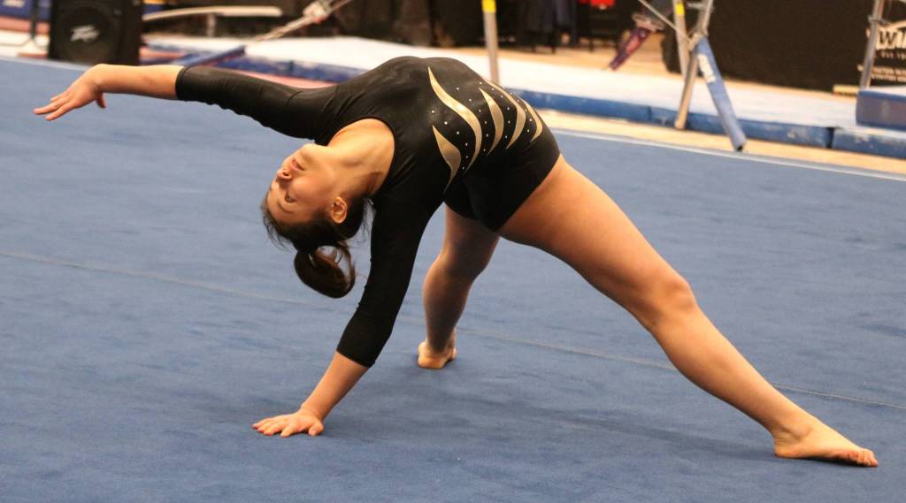 Inglemoors Alexandra Dimitrov stretches toward fifth place on the floor at state. Andy Nystrom / staff photo