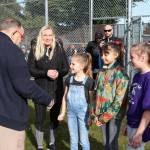 Violet Martinez and her two friends on either side meet Kenmore Mayor David Baker shortly before throwing the first pitch at Moorlands Park. Violet has Lymphoma and has begun to lose her hair after recently finishing her second round of chemo. Photo courtesy of Kenmore