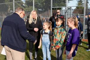 Violet Martinez and her two friends on either side meet Kenmore Mayor David Baker shortly before throwing the first pitch at Moorlands Park. Violet has Lymphoma and has begun to lose her hair after recently finishing her second round of chemo. Photo courtesy of Kenmore