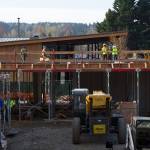 Work crews construct the first floor of Kenmores newest downtown development, the Flyway. The building is adjacent to the Hangar, Kenmores community center, and will be a mixed retail and residential space.