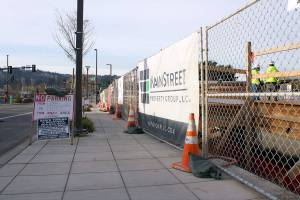 Work crews construct the first floor of Kenmores newest downtown development, the Flyway. The building is adjacent to the Hangar, Kenmores community center, and will be a mixed retail and residential space.