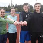 Bothell High athletes, from left, Liza Yusem, Samantha Crumbaugh, Mason Locknane and Jackson Milner grasp onto a relay baton at practice. Andy Nystrom / staff photo
