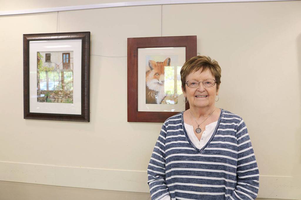 Alta Godwin from Mill Creek next to her displayed art. Stephanie Quiroz/staff photo