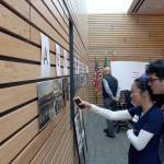 Workshop attendees examine vote on their favorite photo from the For the Love of Kenmore photography contest. Kailan Manandic/staff photo
