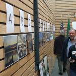 Workshop attendees examine vote on their favorite photo from the For the Love of Kenmore photography contest. Kailan Manandic/staff photo