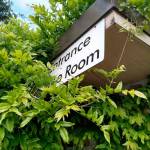 A sign on the gym annex building is nearly overgrown. If a plan is approved by Washington State Parks the building could be remodeled beginning this fall to create an environment education and research center at St. Edward State Park. Aaron Kunkler/staff photo