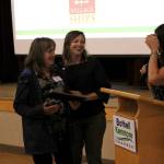 Maurita Colburn, the chambers Member and Community Relations manager, welcomes Country Village owner Leeann Tesorieri as she receives a standing ovation from local business owners. Kailan Manandic/staff photo