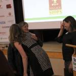 Maurita Colburn, the chambers Member and Community Relations manager, welcomes Country Village owner Leeann Tesorieri as she receives a standing ovation from local business owners. Kailan Manandic/staff photo