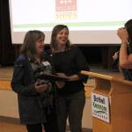 Maurita Colburn, the chambers Member and Community Relations manager, welcomes Country Village owner Leeann Tesorieri as she receives a standing ovation from local business owners. Kailan Manandic/staff photo
