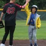 District 8 Blue Jays player Asher Gabarra high fives an FCA Baseball player at second base. Andy Nystrom / staff photo