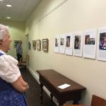Dianne Miller reads about the artists featured in The Art of Alzheimers exhibit, currently at The Gardens at Town Square. Samantha Pak/staff photo
