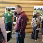 Blake Peterson/staff photo                                A commission staffer chats with a resident at an Aug. 13 meeting.