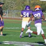 Jaguar head coach Torrey Myers runs up field while cheering on his players. Andy Nystrom/ staff photo