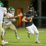 Colby Ryden evades a Redmond tackler. Photo courtesy of Jason Tanaka