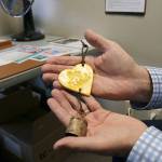 Stephanie Quiroz/staff photo                                 Paul Brown looks at his Be Kind bell he received following the Marysville Pilchuck High School shooting.