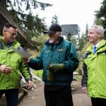 Jim Corcoran (center) passes his property deed to Snohomish County Parks, Recreation and Tourism Department director Tom Teigen (left). Olivia Vanni/staff photo
