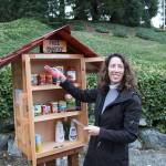 Pastor Anja Helmon adds supplies to the new Little Free Pantry on Oct. 22. Stephanie Quiroz